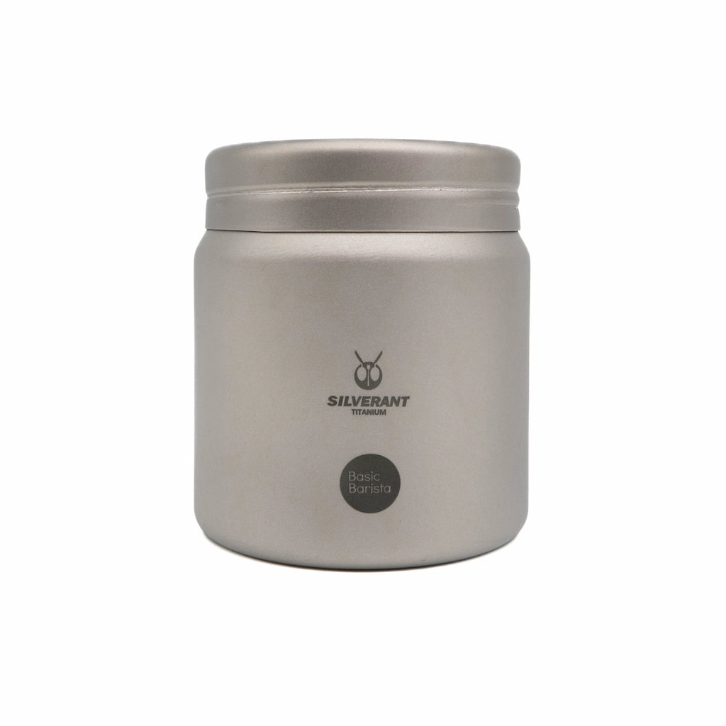 Silver titanium metal container with coffee beans on a white background Basic Barista Coffee Gear Logo Etched Coffee Bean Storage container