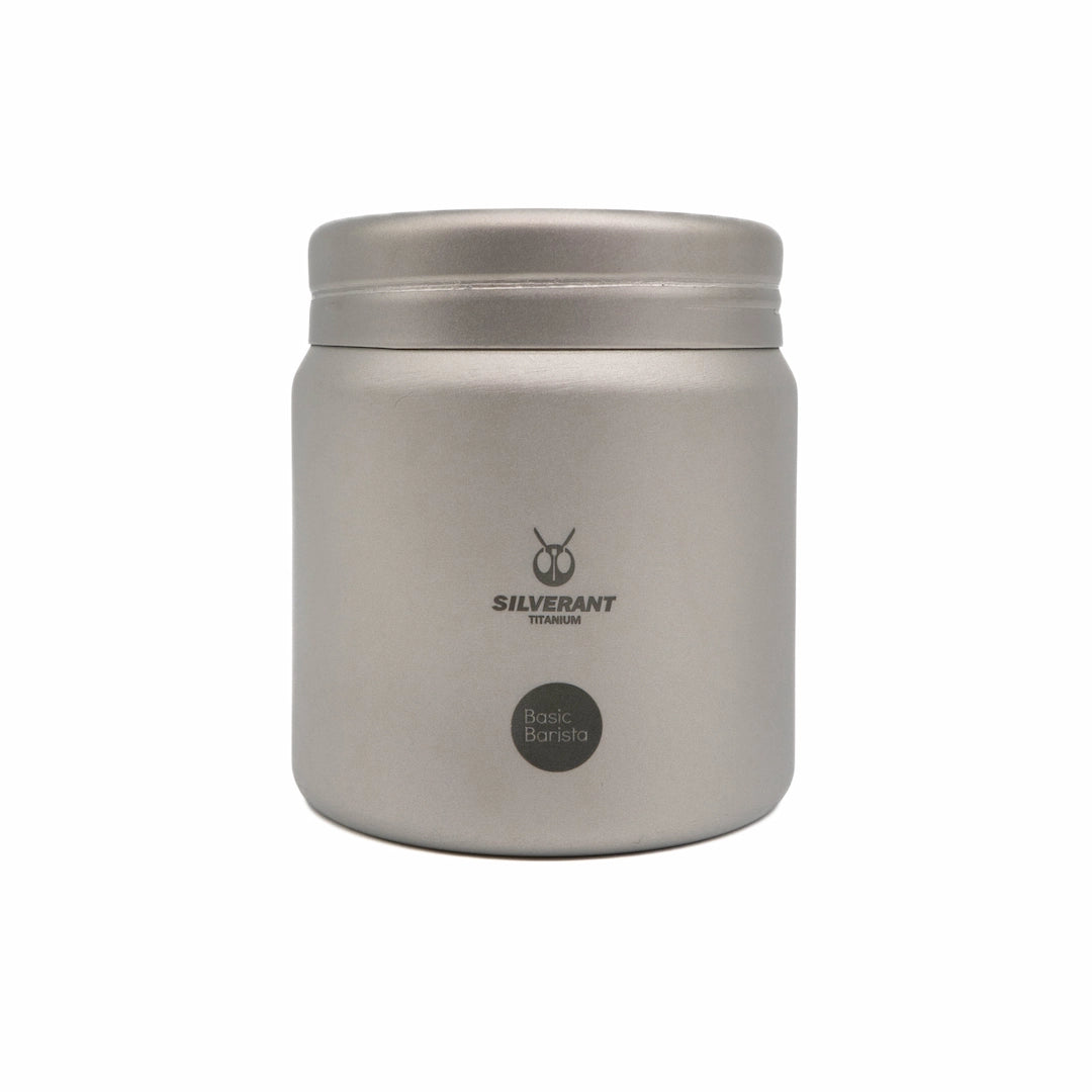 Silver titanium metal container with coffee beans on a white background Basic Barista Coffee Gear Logo Etched Coffee Bean Storage container