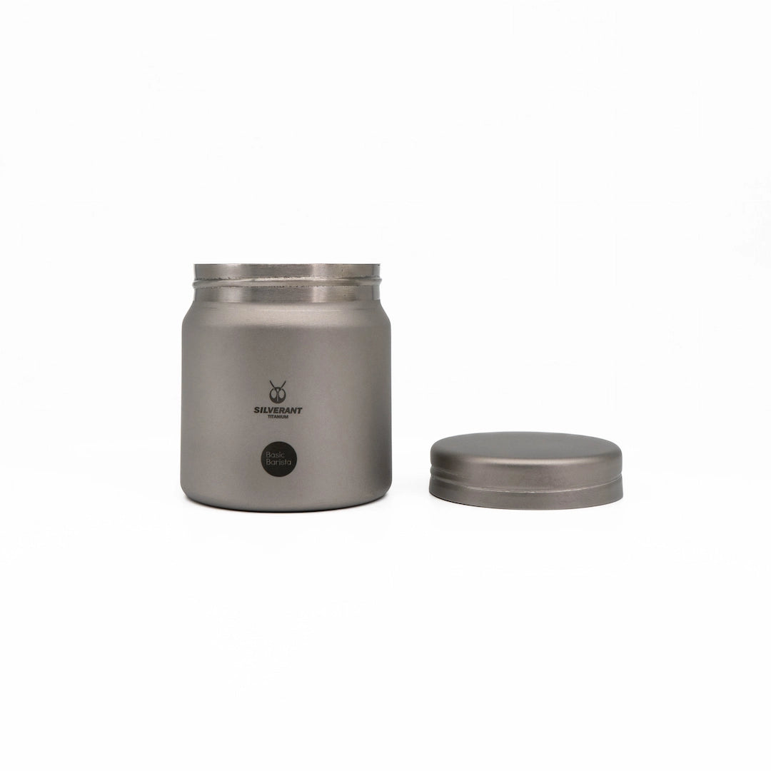 Silver titanium metal container with coffee beans on a white background Basic Barista Coffee Gear Logo Etched Coffee Bean Storage container 