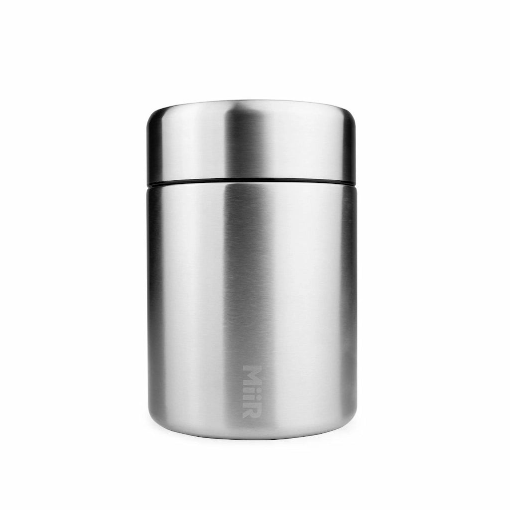 Stainless steel thermos canister on a white background