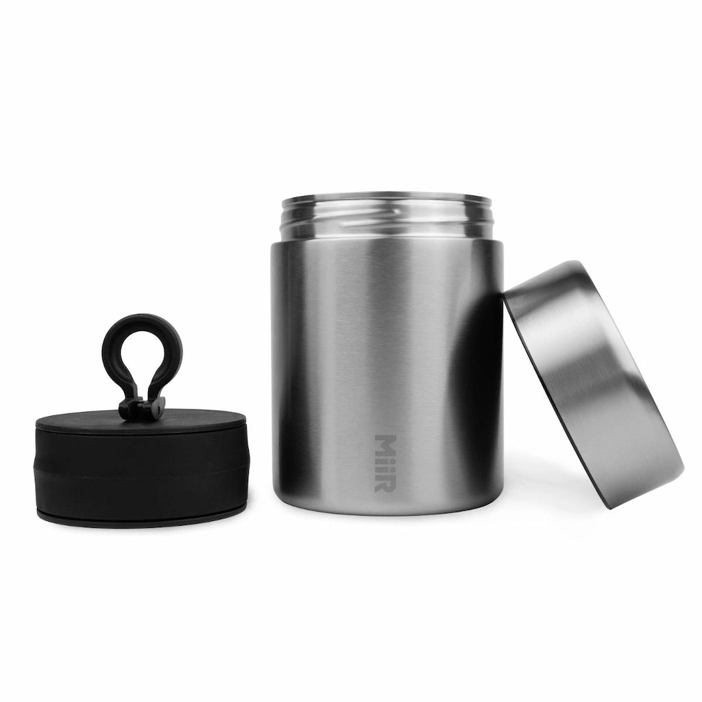 Stainless steel food jar with black lid on a white background airtight coffee bean storage canister Bean Storage Canisters